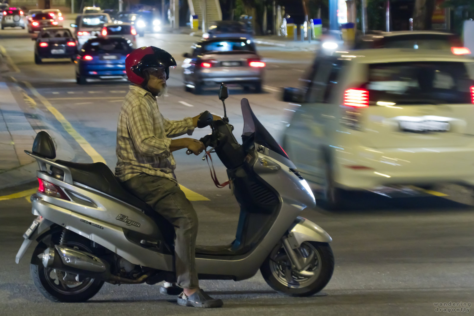 Motorbike gives precendence -- car, motorbike, night, traffic