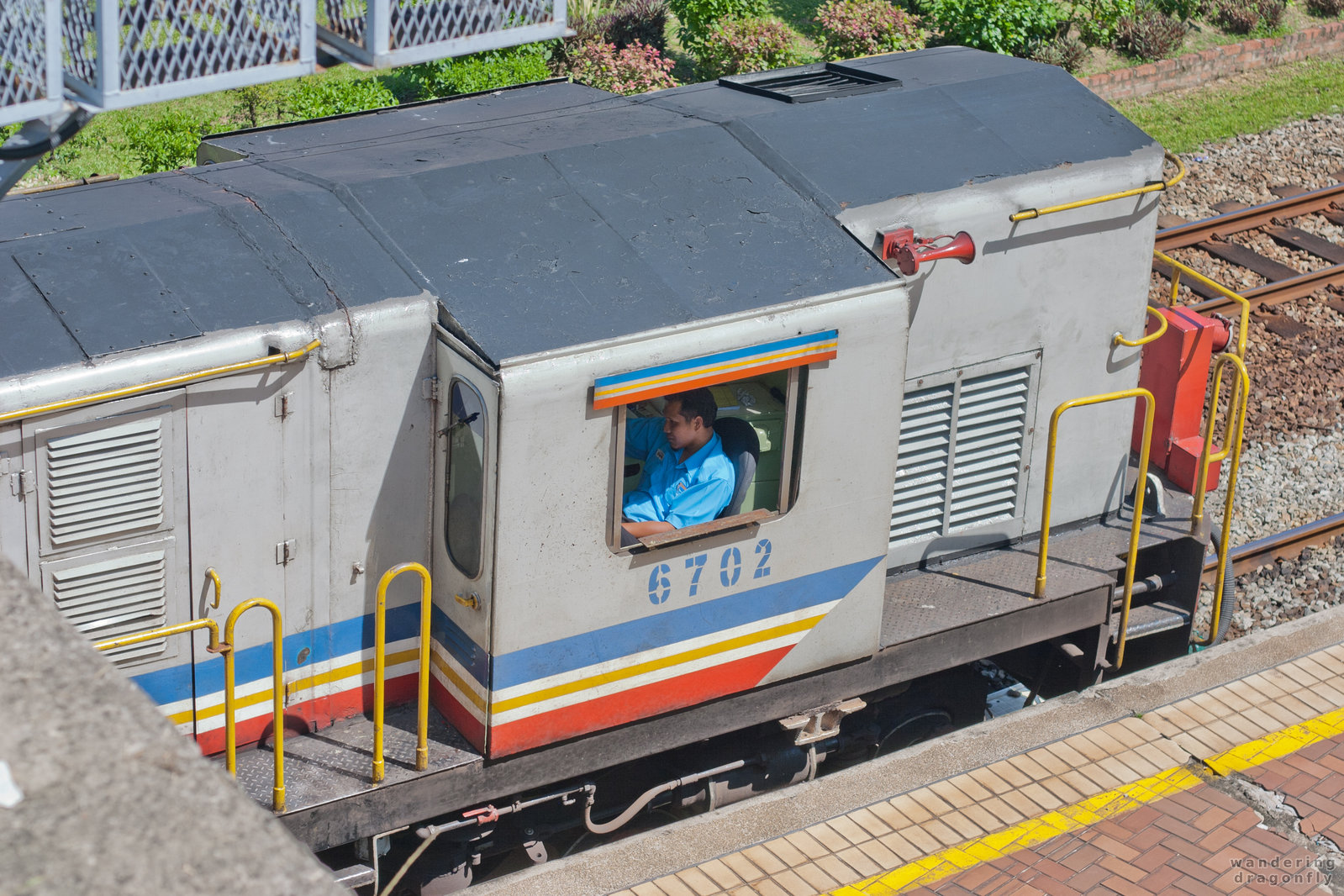 Engine driver in a small box -- train, train station