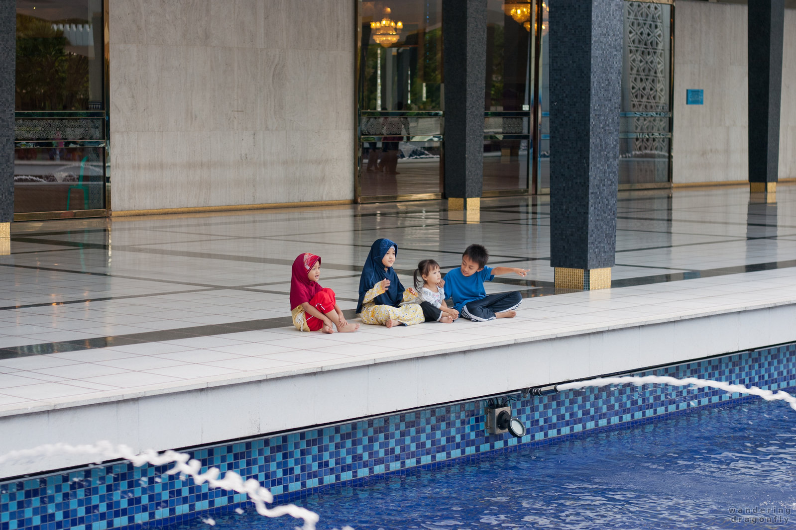 Amazed children by the pool -- mosque, pool