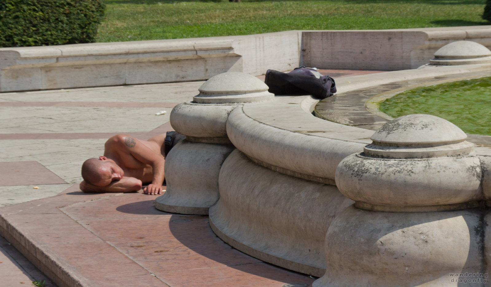 Having a nap? -- fountain, sleeping, tourist