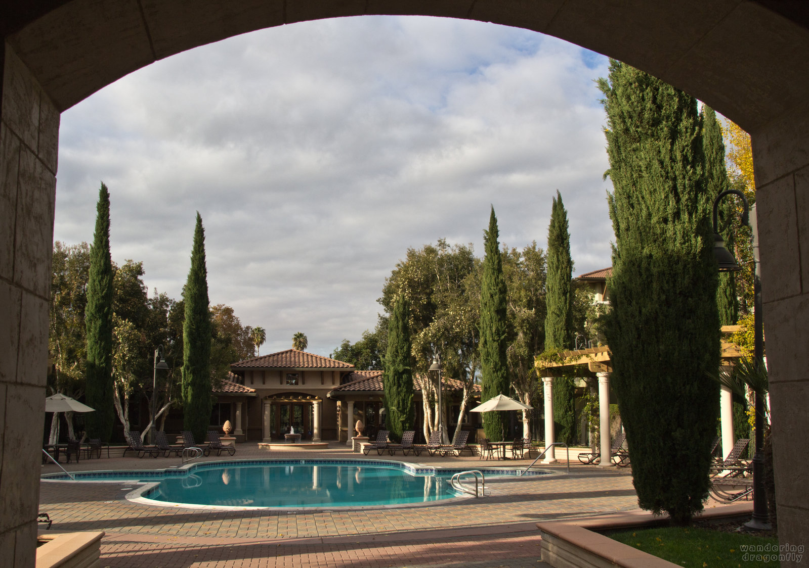 View from the gym -- arch, building, pool, reflection, tree