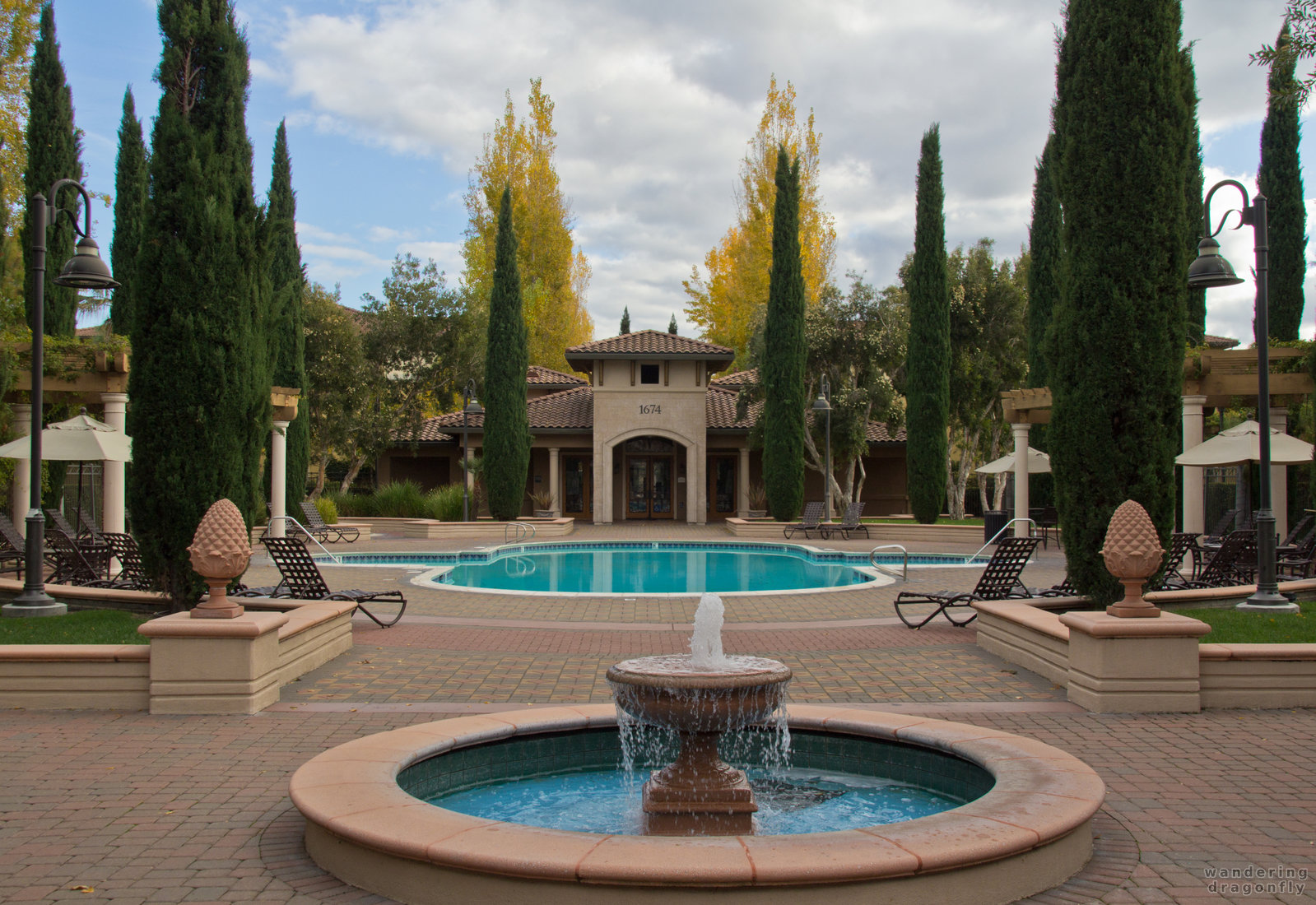 View from the clubhouse -- building, fountain, tree