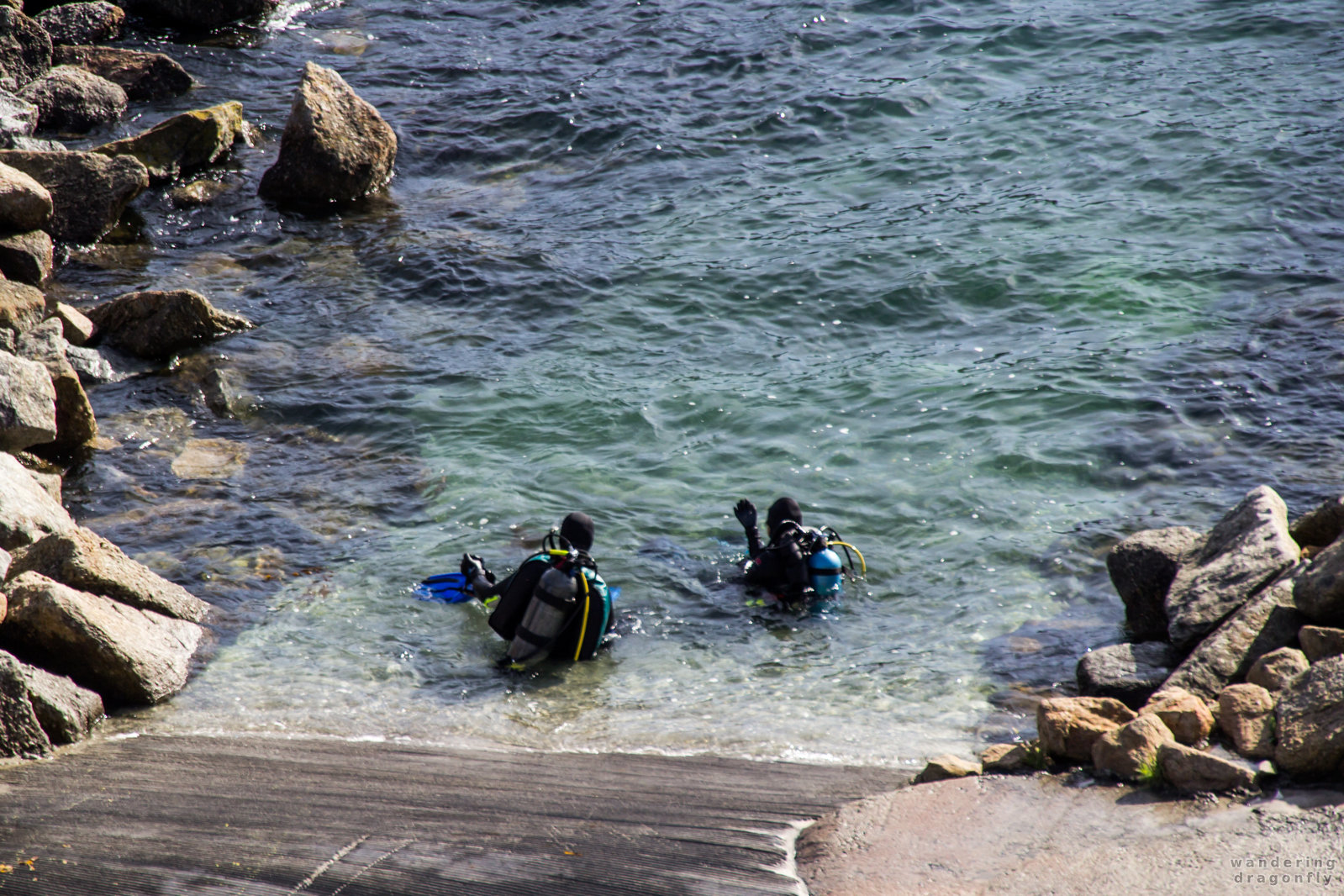 Scuba divers enter the water at Whalers Cove -- ocean, rock, scuba diver, water