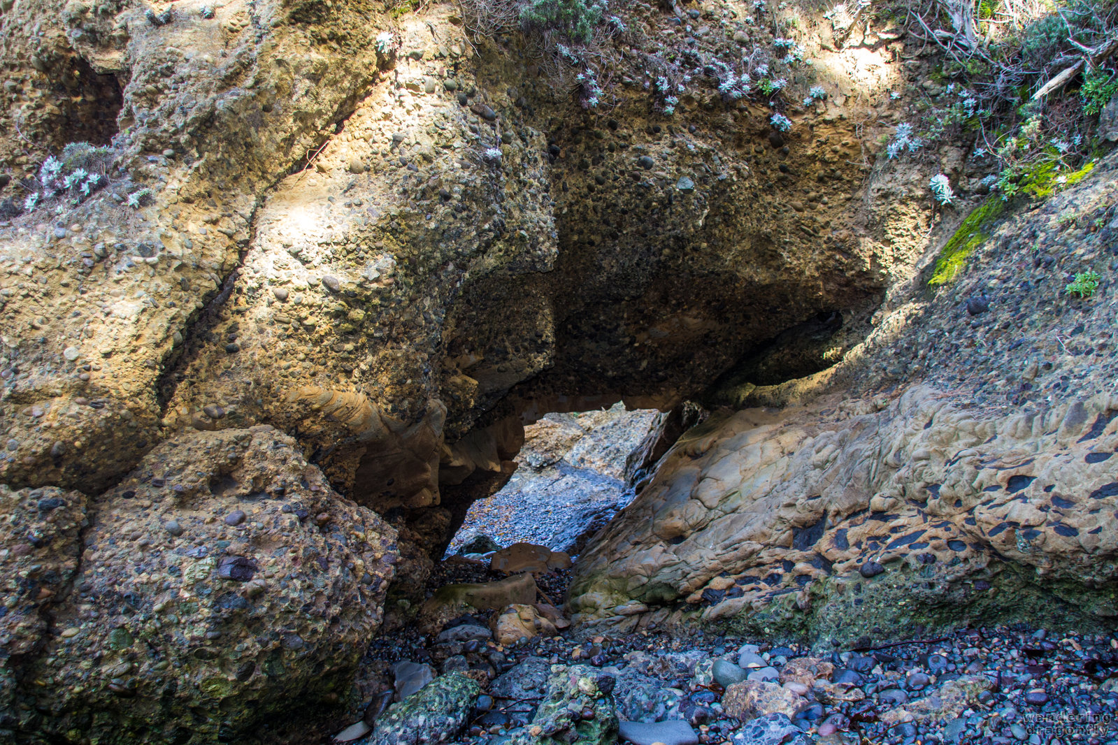 Hole in the wall -- gravel, hole, rock