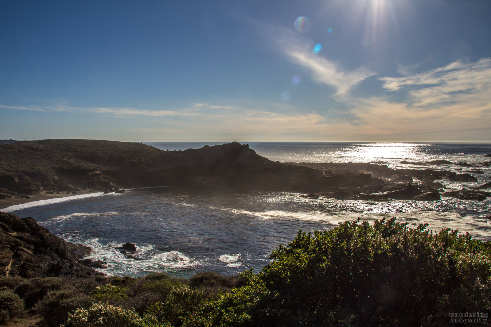 Headland Cove -- cliff, cove, ocean, rock, sky, sun beam, water