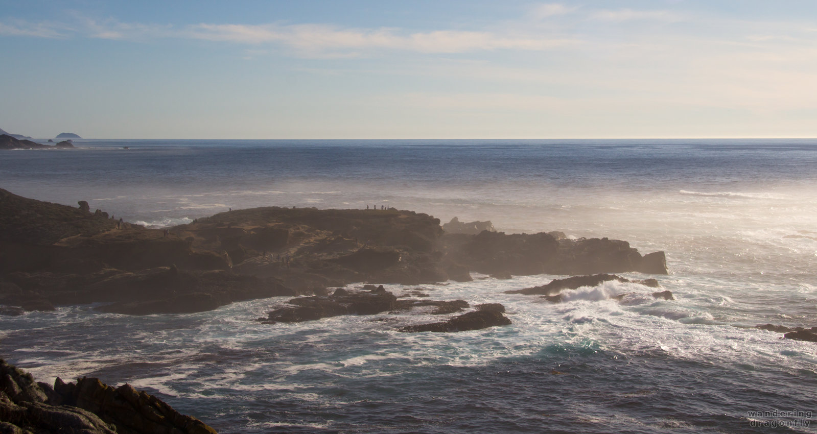 Misty shore -- cliff, hiker, ocean fog, rock, sky, water