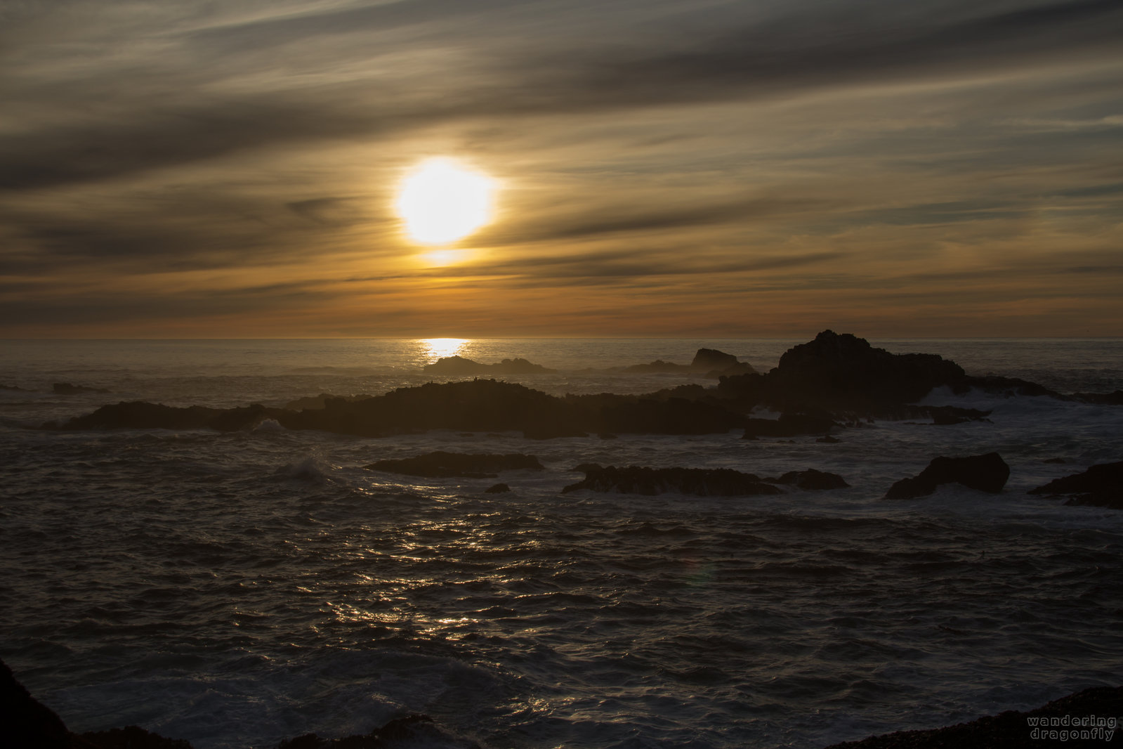 Waves and reflections -- cloud, ocean, rock, sun, sunset, water, wave