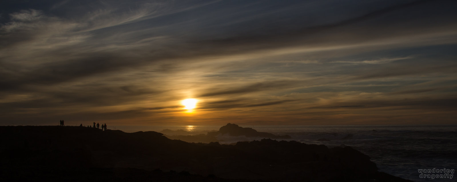 Hikers in the sunset -- cliff, cloud, hiker, ocean, rock, sun, sunset, water, wave