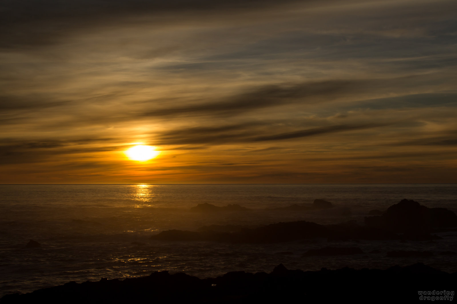 Misty sunset -- cloud, ocean, rock, sun, sunset, water, wave