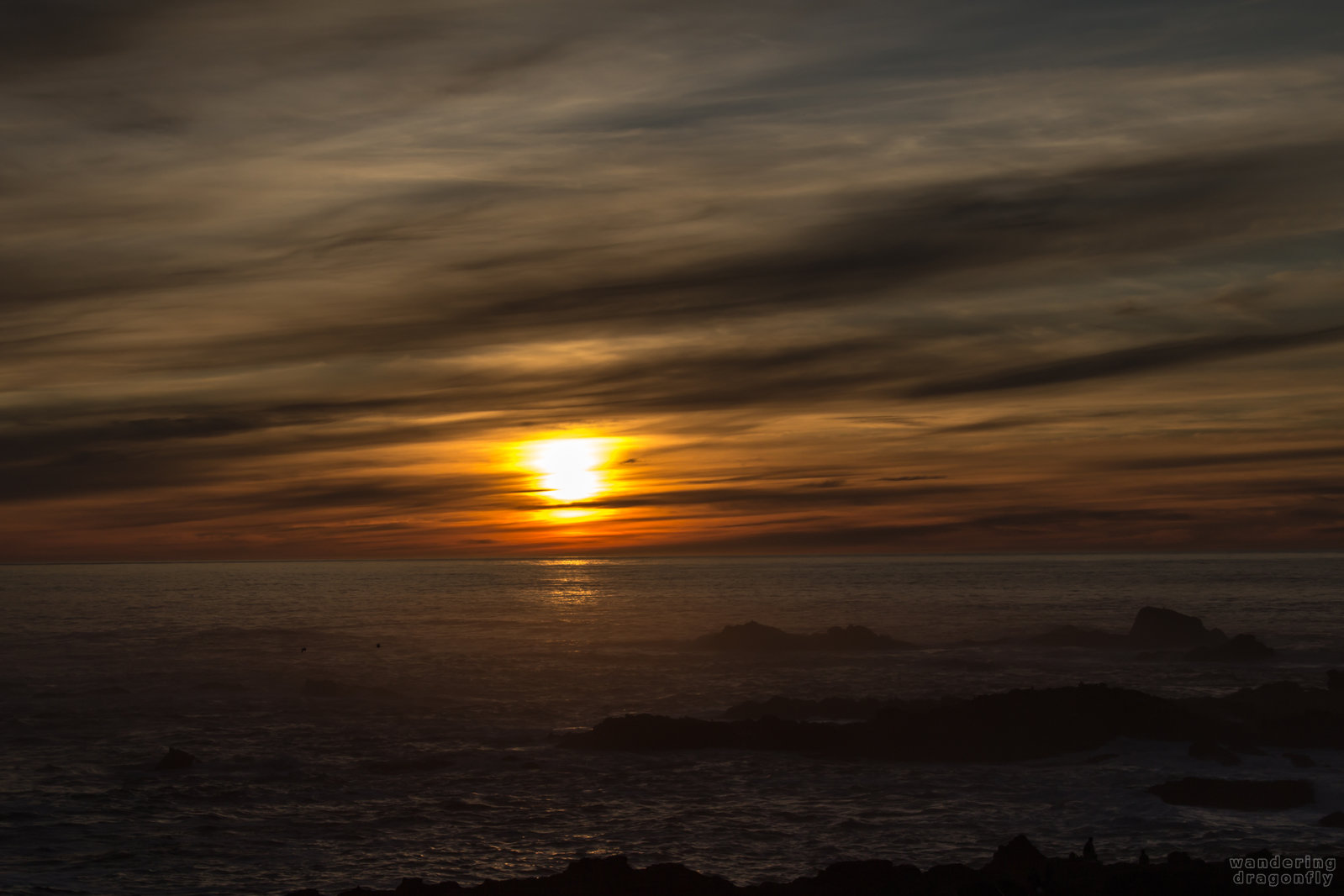 Birds and clouds at sunset -- cloud, ocean, rock, sun, sunset, water, wave