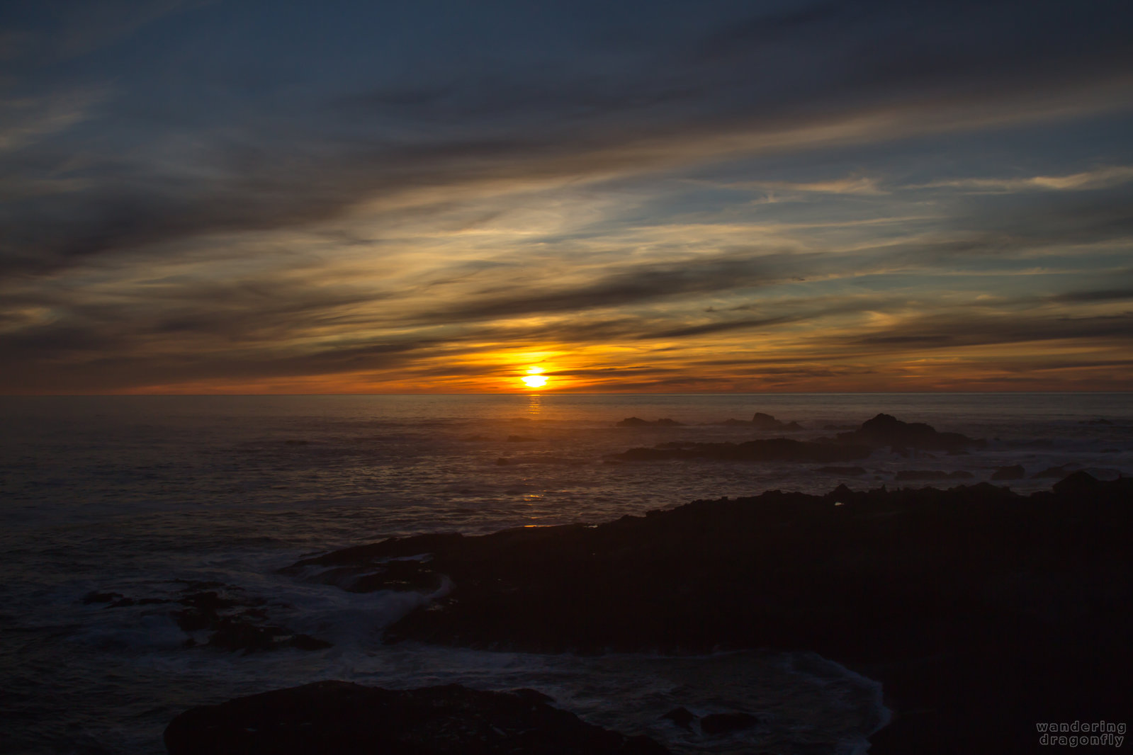 Sea Lion Cove at sunset -- cliff, cloud, cove, ocean, rock, sun, sunset, water, wave