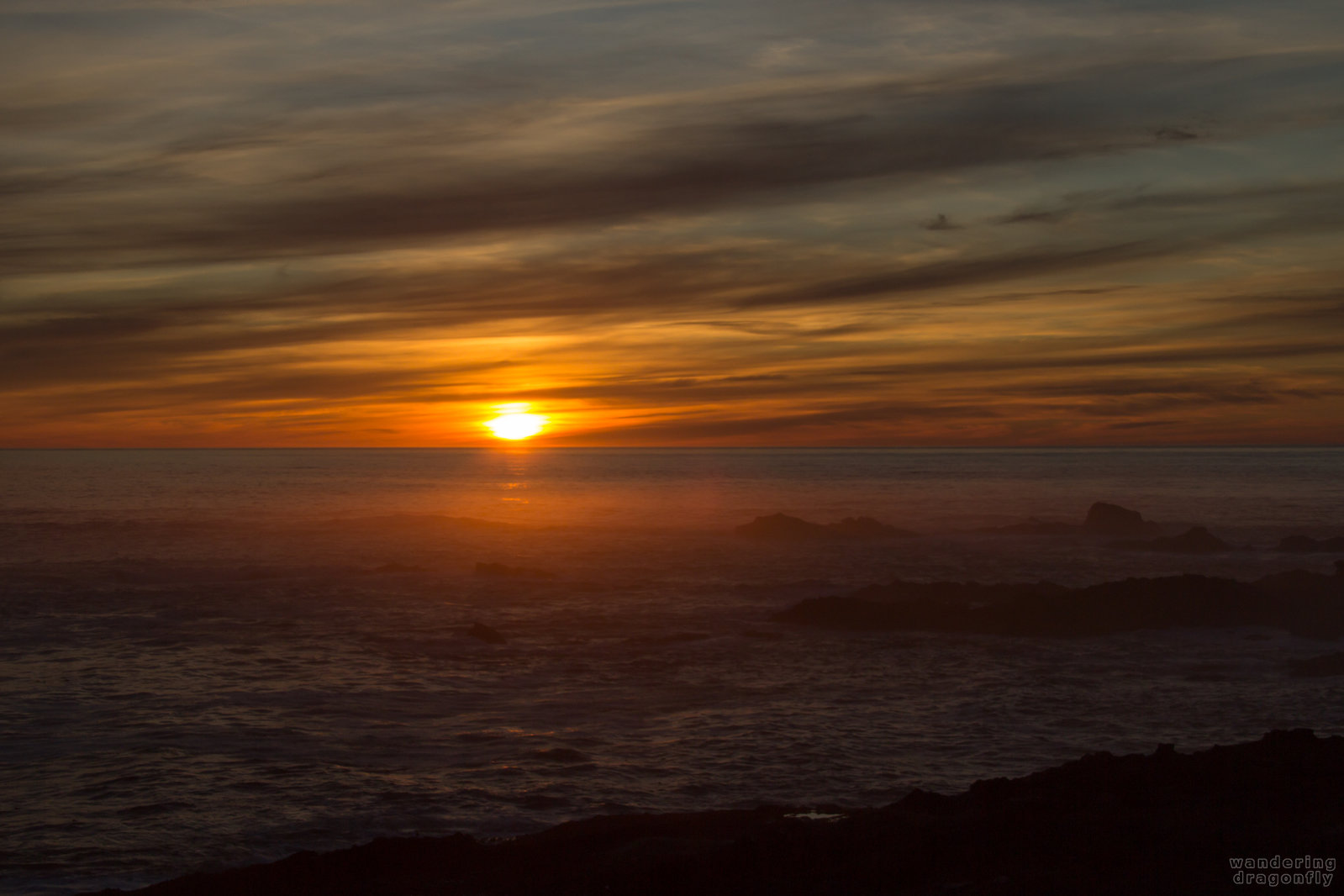 Very red -- cloud, ocean, red, rock, sun, sunset, water, wave