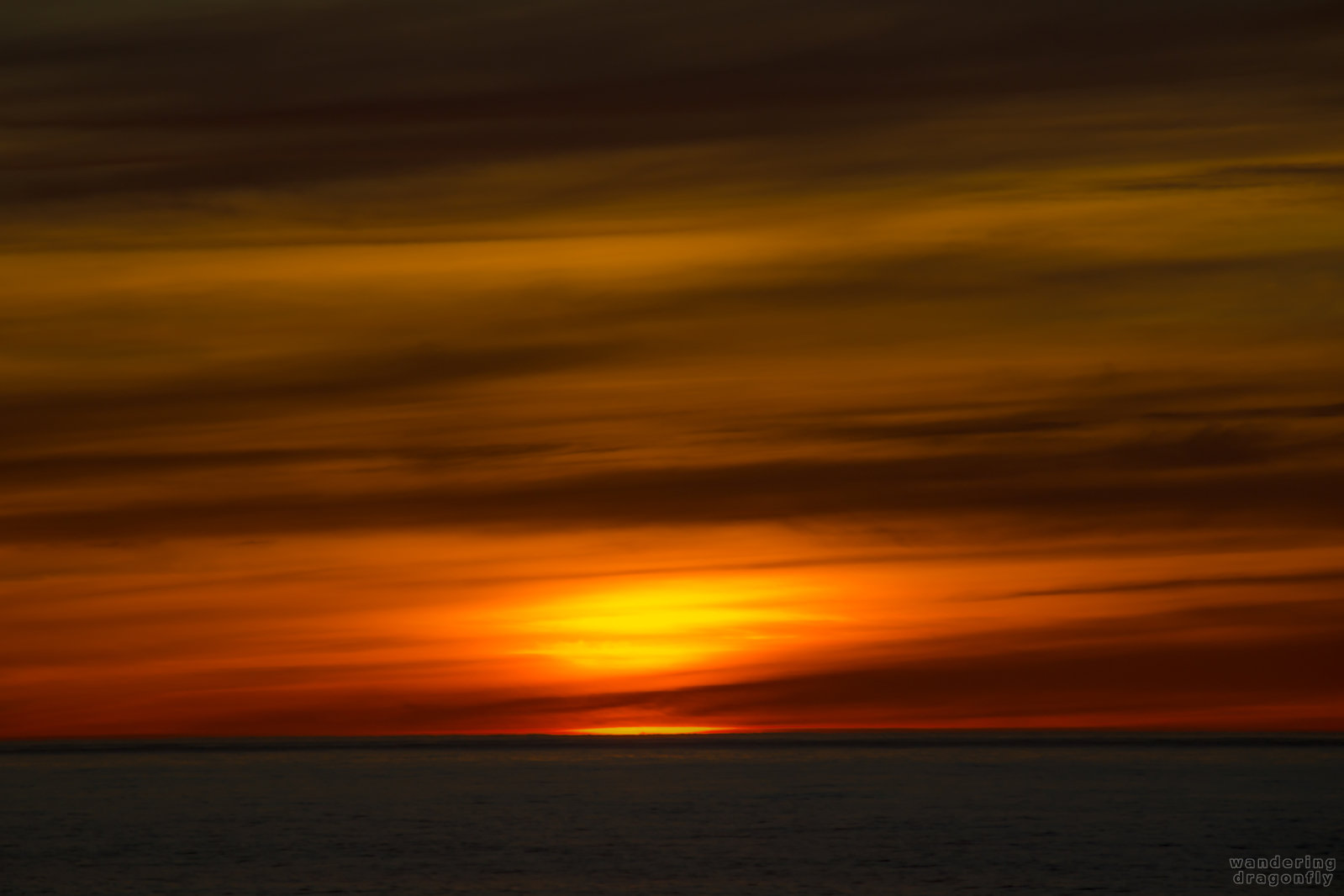 Blurred fire -- cloud, ocean, red, sun, sunset, water