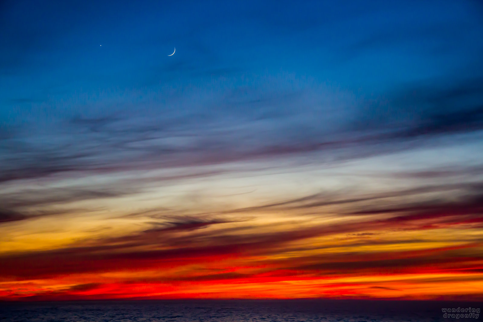 Venus and Moon on the scene -- blue, cloud, moon, ocean, orange, purple, red, sunset, venus, water, white, yellow