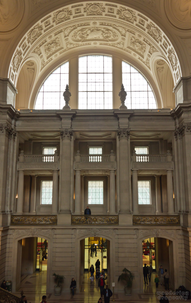 Northern wing of the City Hall -- people, pillar, relief, statue