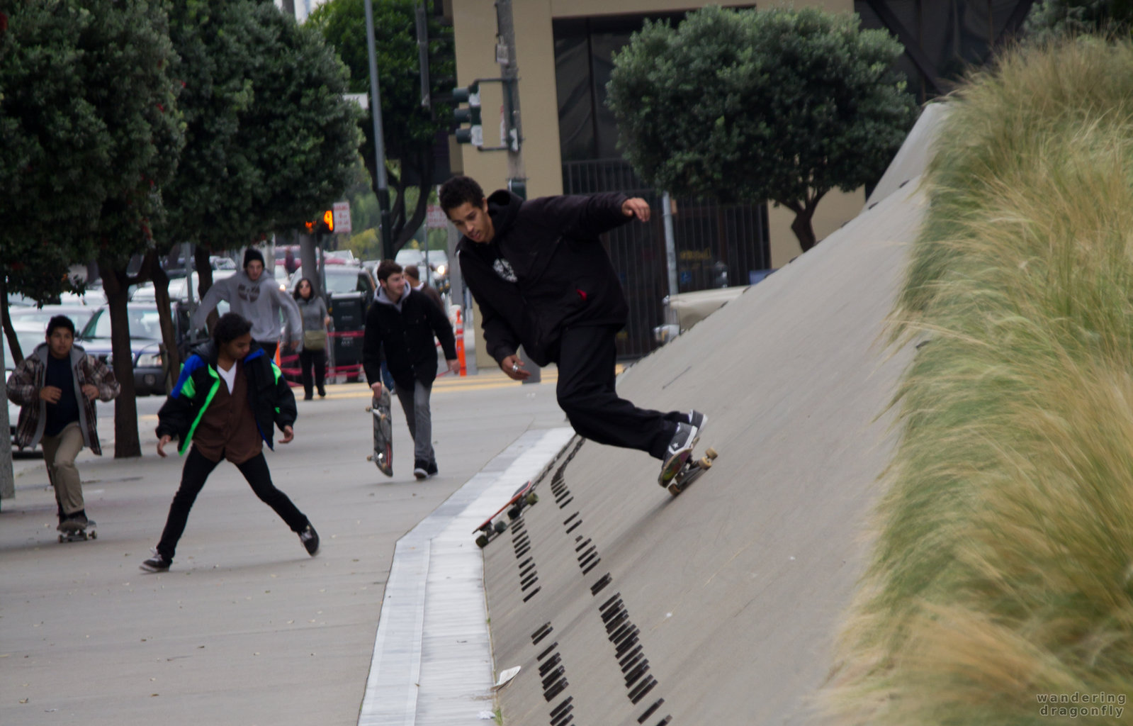 Skateboarders in front of the Phillip Burton Federal Building -- boy, skateboard, street