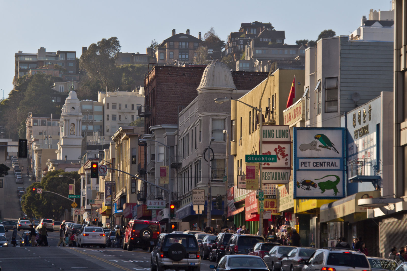 A glimpse at Chinatown on Broadway with Nob Hill in the background -- building, street