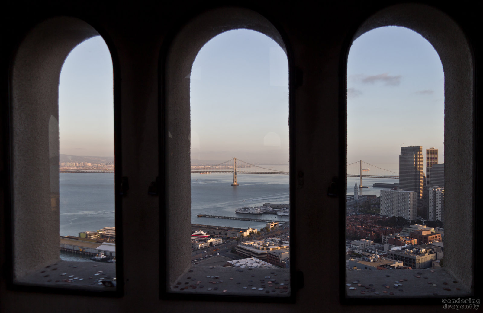 Looking through the windows of Coit Tower at the Bay Bridge -- building, vista
