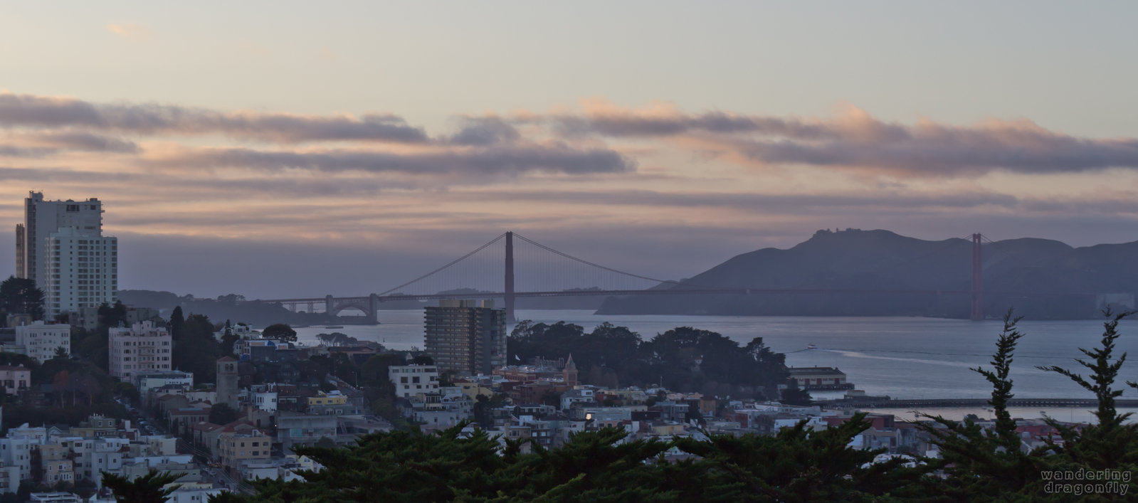 The Golden Gate Bridge at twilight as seen from the Coit Tower -- bridge, building