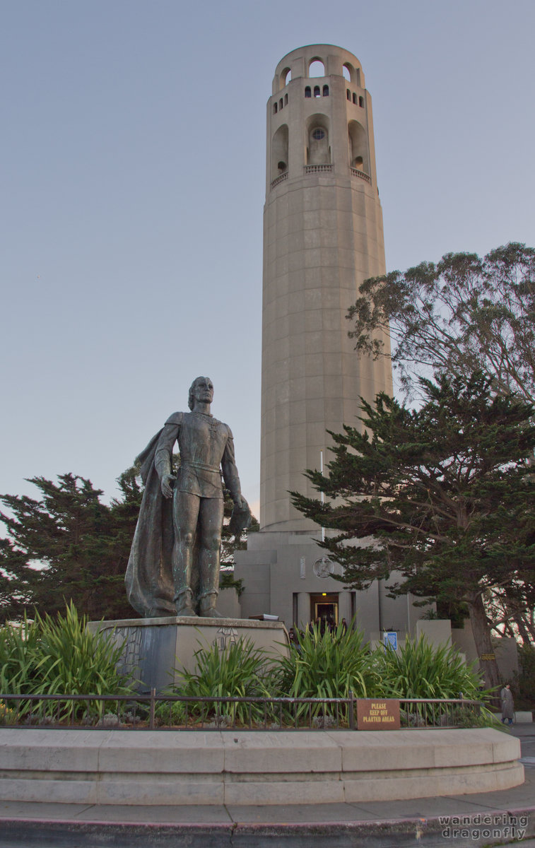 Picture of the Coit tower with the statue of Columbus in the foreground -- statue, tower