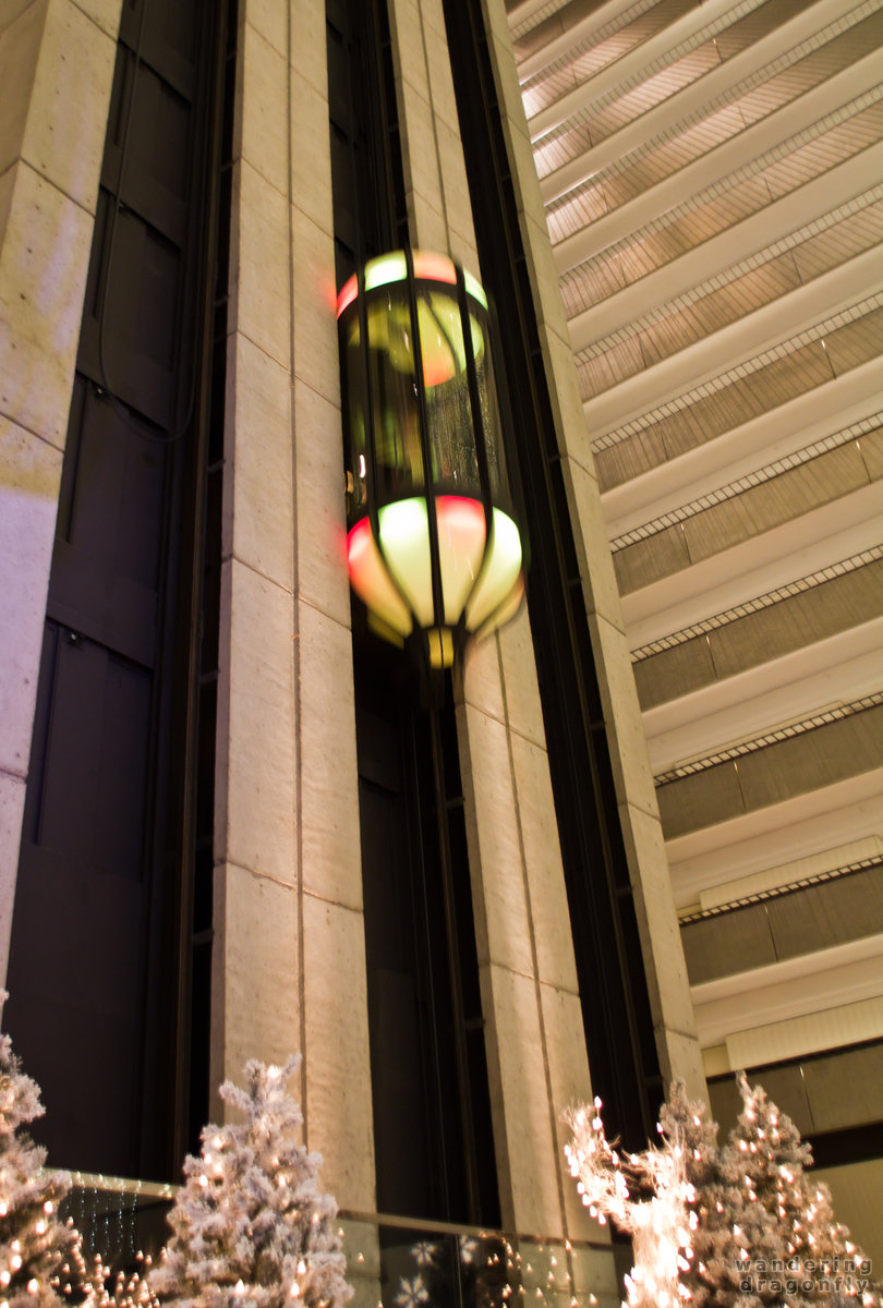 One of the five pill-shaped elevators by John Portman in the Hyatt Regency -- christmas decoration, elevator
