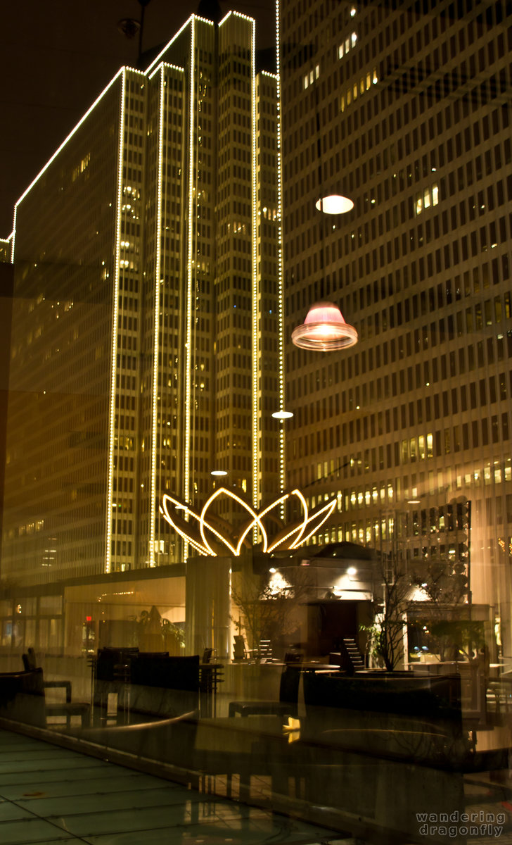 The outside of the Embarcadero Center with the inside reflections of the Hyatt Hotel -- building, christmas decoration, lighting, night