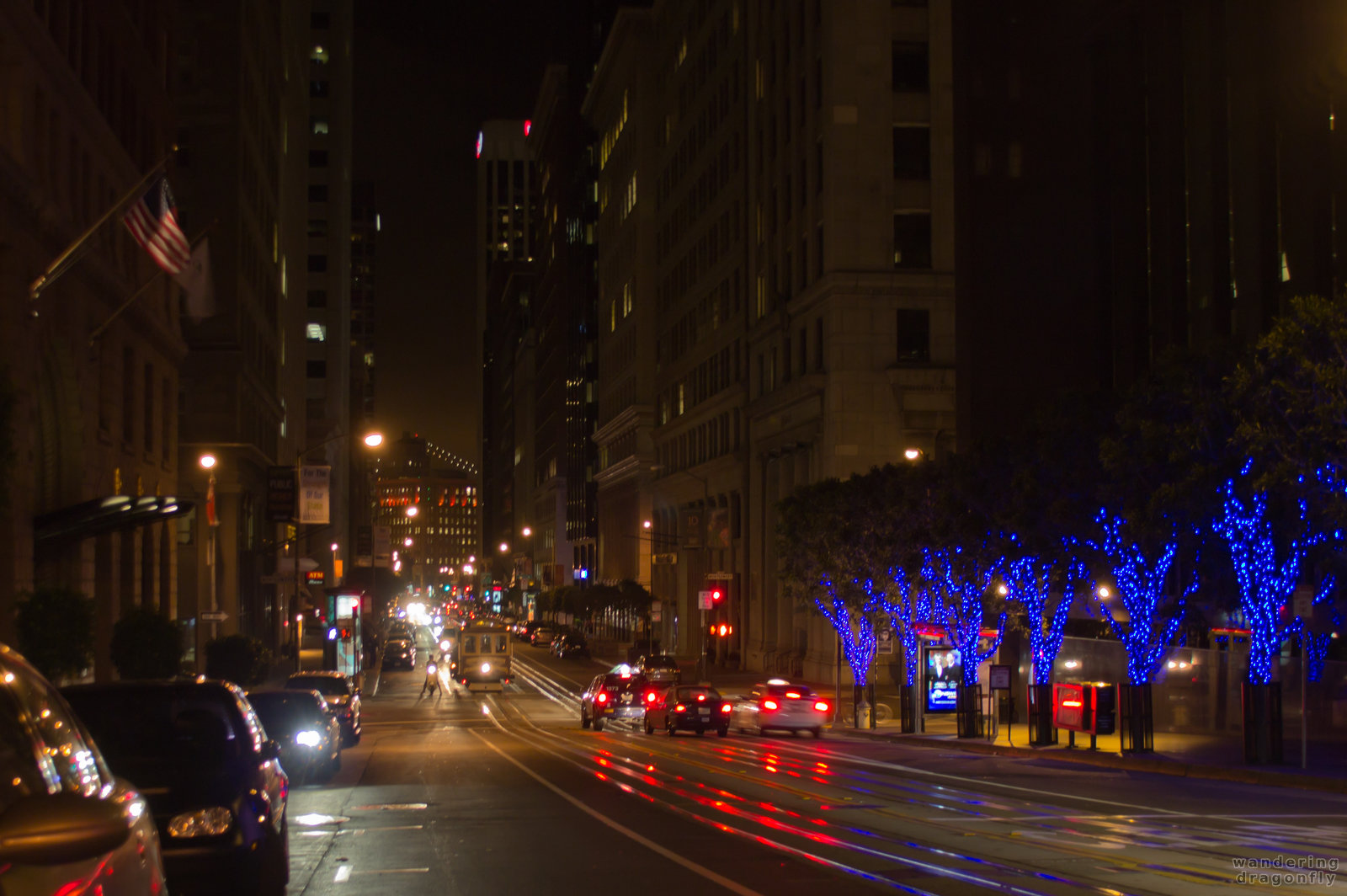 Cable car arriving in the evening on California Street -- cable car, christmas decoration, lighting, night, street